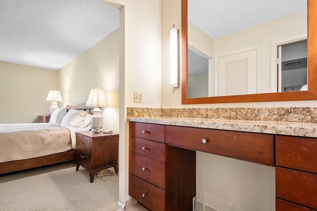 bathroom with vanity and a textured ceiling