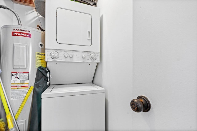 washroom featuring stacked washer and clothes dryer and water heater