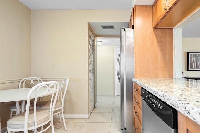 kitchen featuring stainless steel appliances and light tile patterned floors