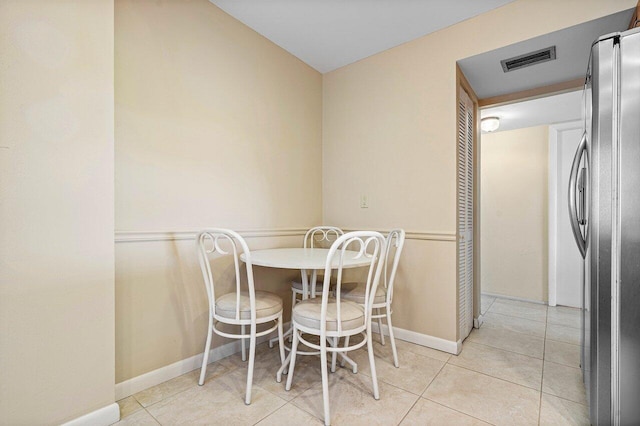 dining area with light tile patterned floors