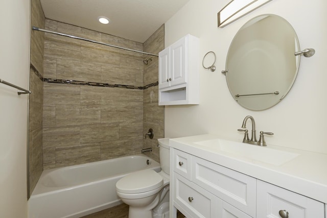 full bathroom with tiled shower / bath combo, toilet, and vanity