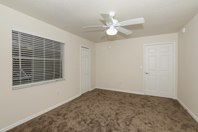 unfurnished bedroom with ceiling fan, carpet, and a textured ceiling