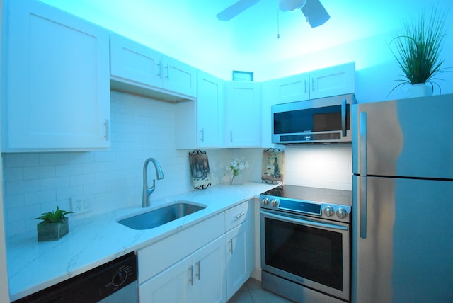 kitchen featuring ceiling fan, backsplash, stainless steel appliances, and sink