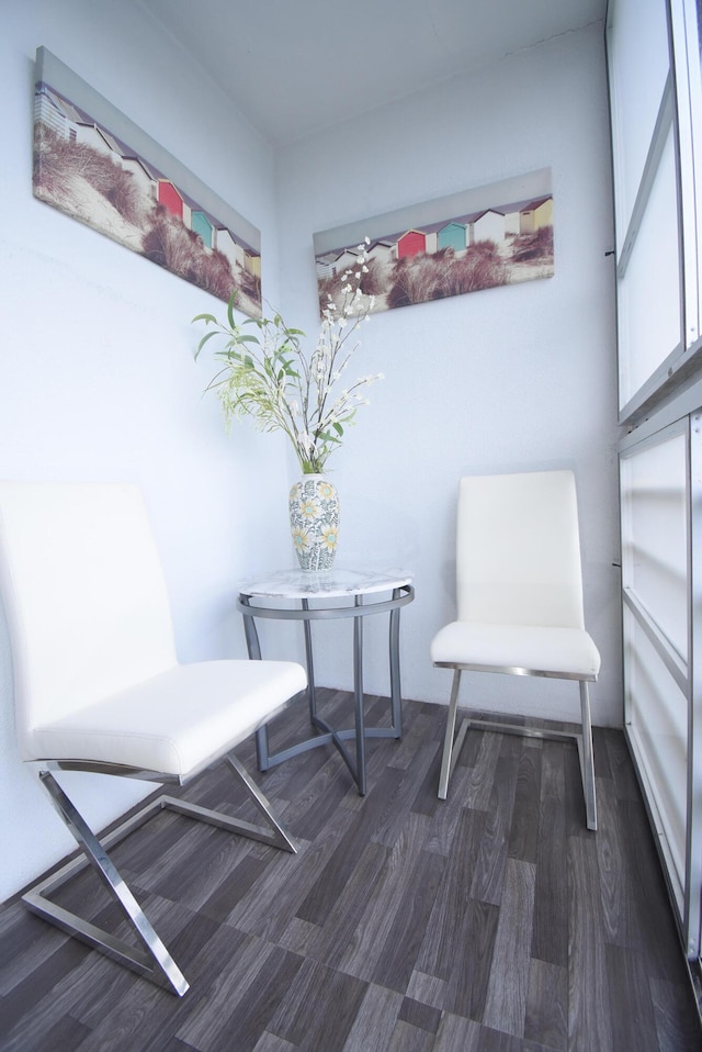 sitting room with dark wood-type flooring