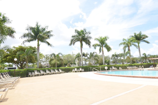 exterior space with a community pool and a patio