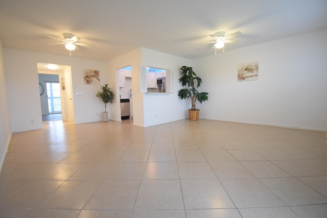 spare room with ceiling fan and light tile patterned floors