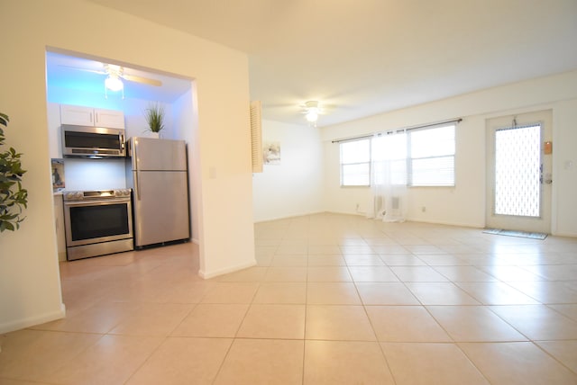 unfurnished living room with ceiling fan and light tile patterned floors