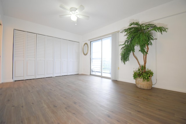 unfurnished bedroom with dark wood-type flooring, ceiling fan, and access to exterior