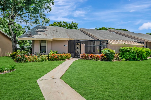 ranch-style house with a front lawn