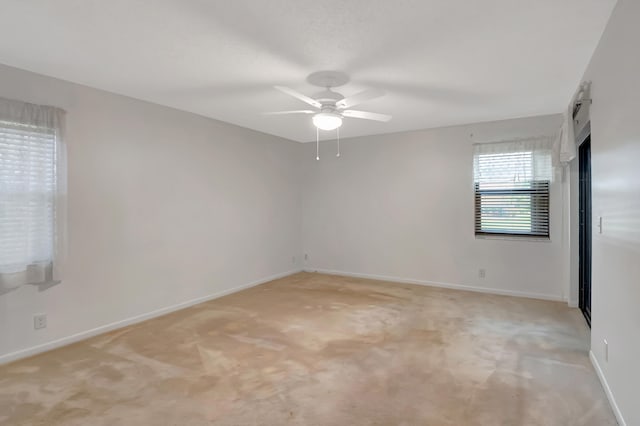 carpeted empty room featuring ceiling fan