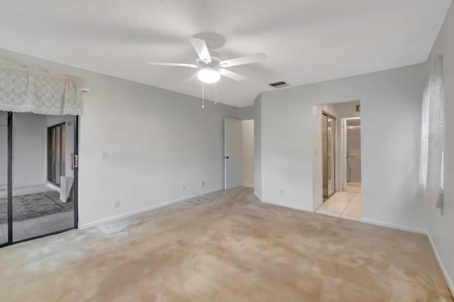 unfurnished bedroom featuring ceiling fan, connected bathroom, and light colored carpet