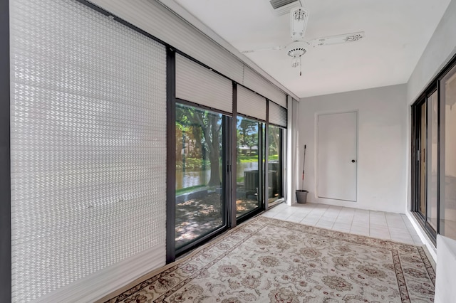 interior space featuring ceiling fan and light tile patterned floors