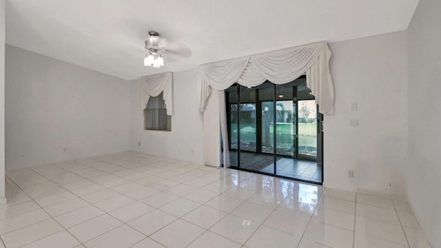 unfurnished room with ceiling fan and light tile patterned floors