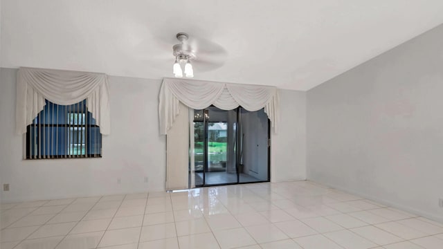 unfurnished room with ceiling fan and light tile patterned floors