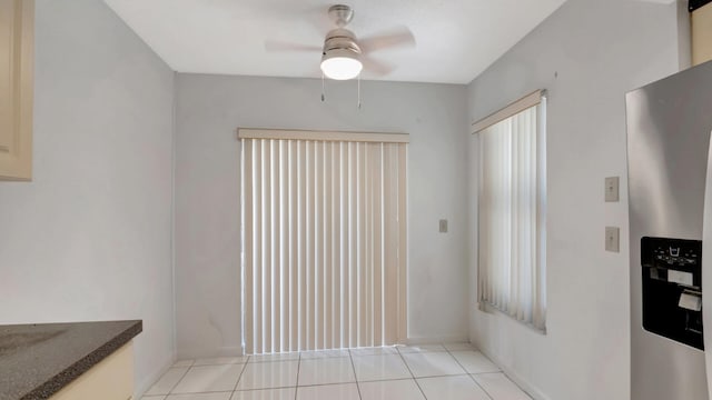 interior space with ceiling fan and light tile patterned floors