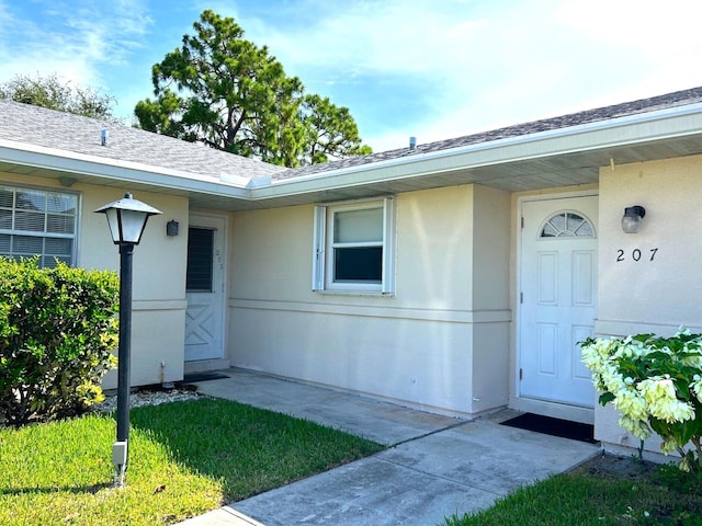 doorway to property featuring a yard