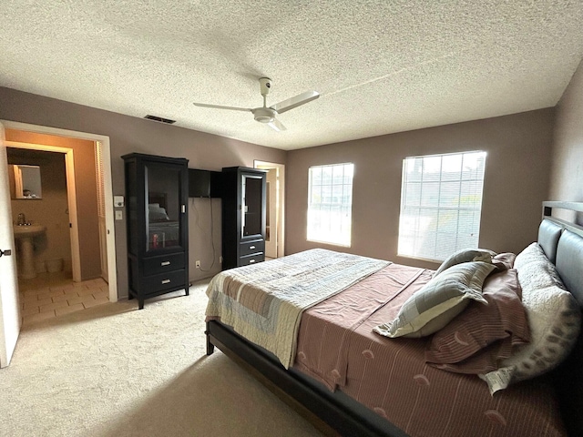 tiled bedroom with ceiling fan and a textured ceiling