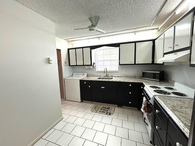 kitchen featuring white range oven, sink, washer / dryer, ceiling fan, and a textured ceiling