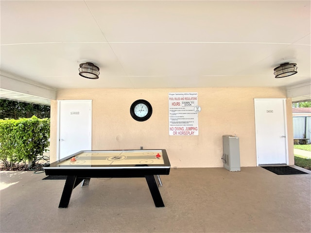 recreation room featuring concrete flooring