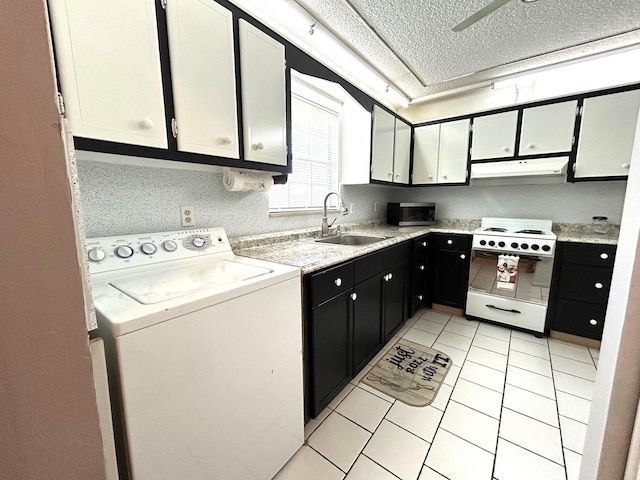 laundry room with washer / clothes dryer, light tile patterned floors, a textured ceiling, and sink