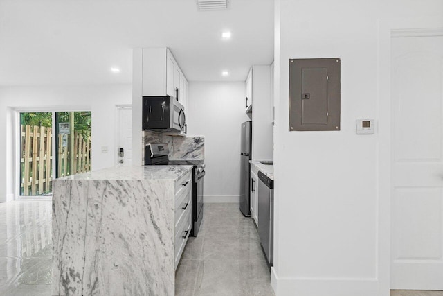 kitchen with tasteful backsplash, stainless steel appliances, white cabinetry, electric panel, and light stone counters