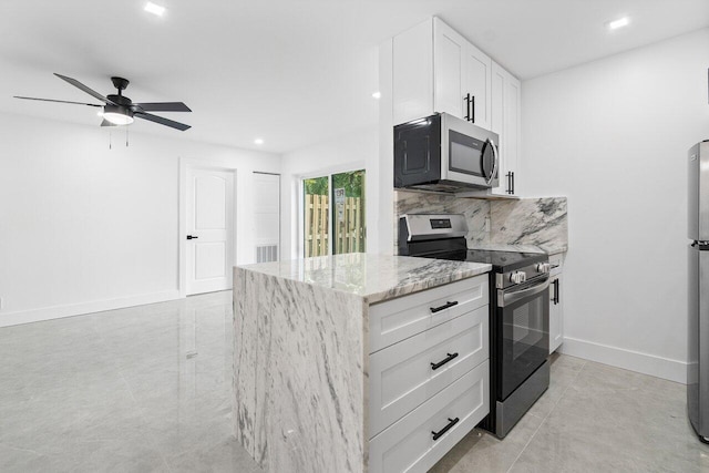 kitchen featuring white cabinetry, backsplash, light tile patterned floors, ceiling fan, and appliances with stainless steel finishes