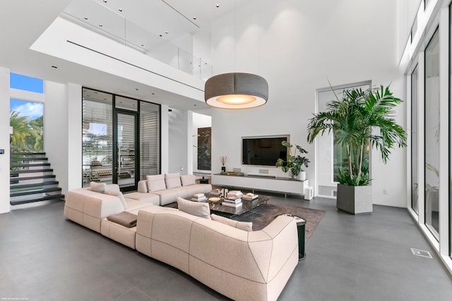 living room featuring a high ceiling