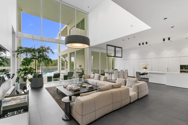 living room with a high ceiling and a water view