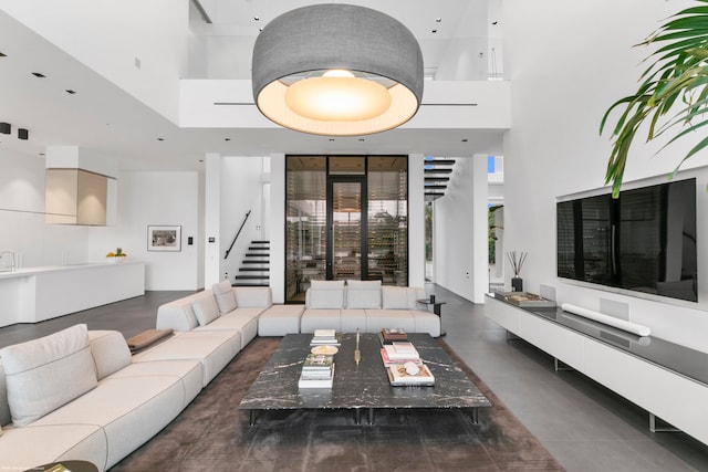 living room featuring a towering ceiling