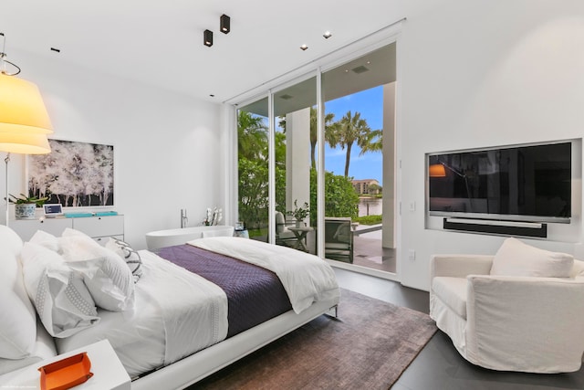 bedroom featuring floor to ceiling windows and access to exterior