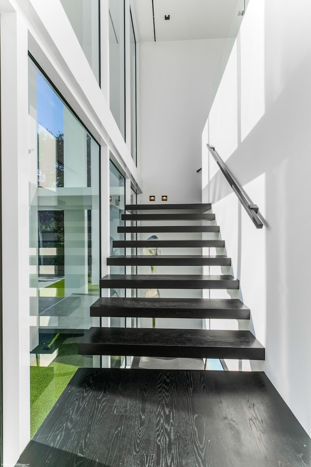 staircase with a high ceiling