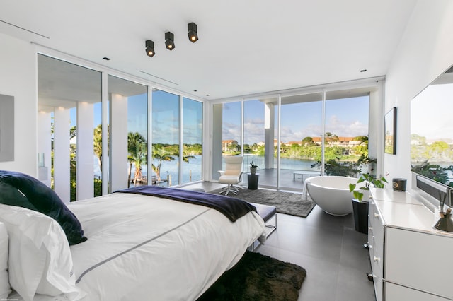 bedroom with floor to ceiling windows and access to outside