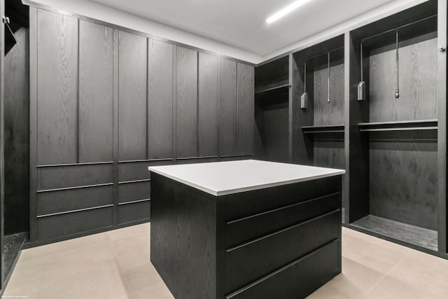 walk in closet featuring light tile patterned flooring