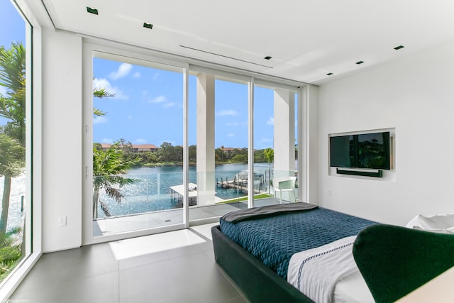 bedroom featuring floor to ceiling windows, access to exterior, and multiple windows