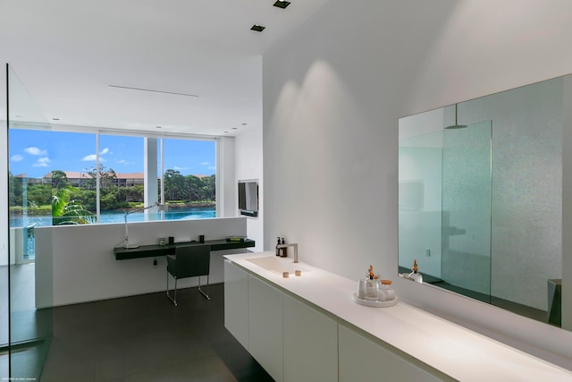 bathroom with floor to ceiling windows, concrete flooring, walk in shower, and vanity