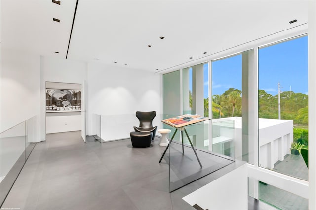 interior space featuring concrete flooring and floor to ceiling windows