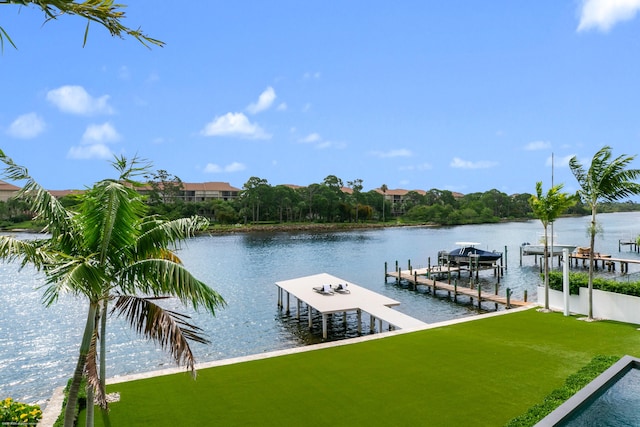 dock area featuring a lawn and a water view