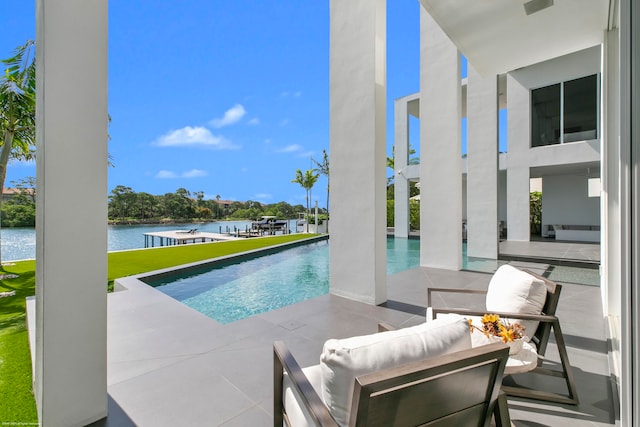 view of pool featuring an outdoor hangout area, a water view, and a patio