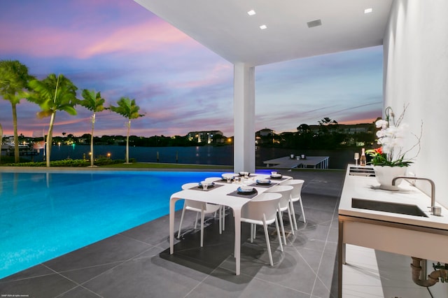 pool at dusk featuring sink