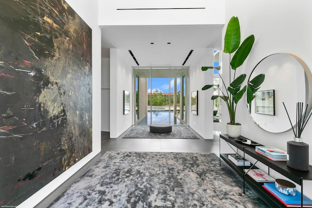 hall with tile patterned floors