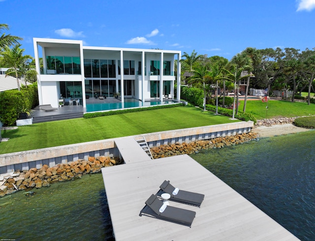 view of dock featuring a lawn