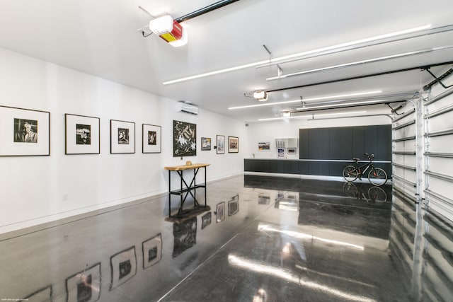 garage featuring a wall unit AC and a garage door opener