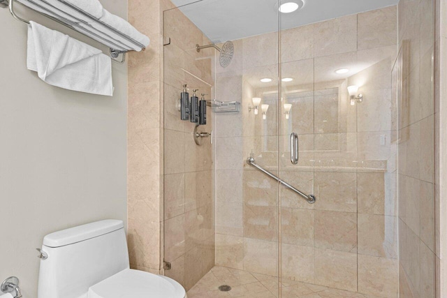 full bath featuring a stall shower and toilet