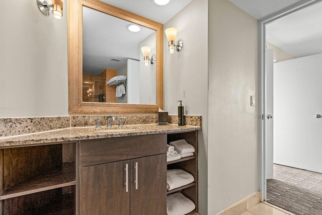 bathroom with visible vents, vanity, and tile patterned floors