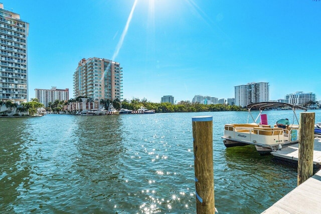 view of dock with a view of city and a water view