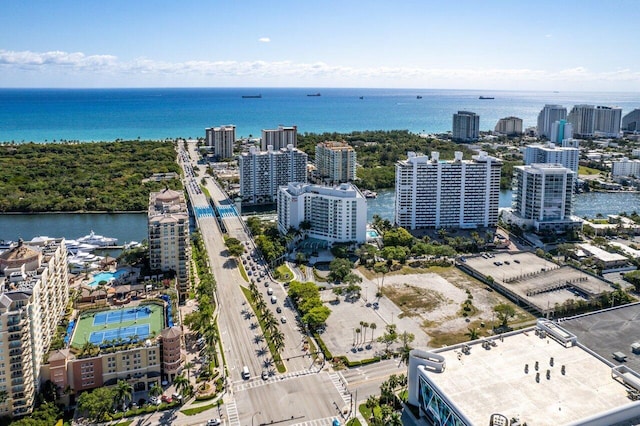 birds eye view of property featuring a water view and a city view