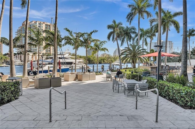 view of community featuring a water view and a patio area