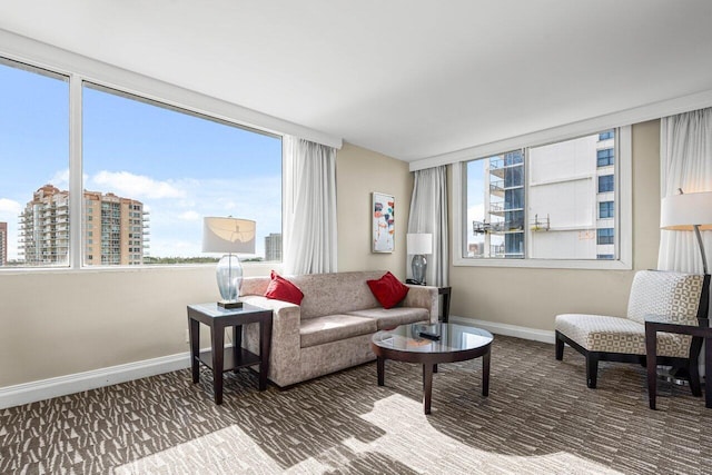 living room featuring a city view and baseboards