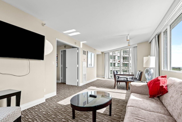 living room featuring carpet, visible vents, and baseboards