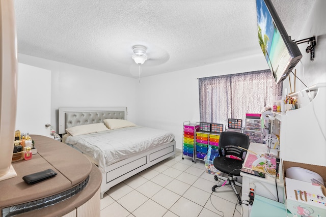 bedroom featuring a textured ceiling, light tile patterned flooring, and ceiling fan